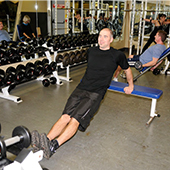 man exercising in weightroom